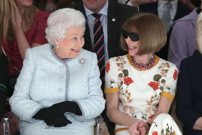LONDON, ENGLAND - FEBRUARY 20: Queen Elizabeth II sits next to Anna Wintour as they view Richard Quinn's runway show before presenting him with the inaugural Queen Elizabeth II Award for British Design as she visits London Fashion Week's BFC Show Space on February 20, 2018 in London, United Kingdom. (Photo by Yui Mok - Pool/Getty Images)