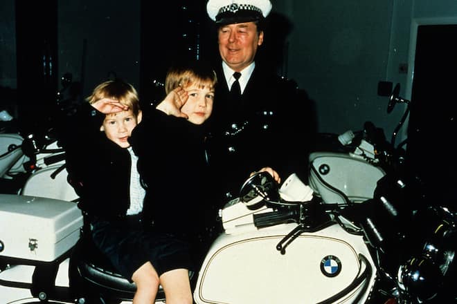 WINDOSR- NOVEMBER: (FILE PHOTO) Prince William and Prince Harry give a royal salute from atop a police motorbike during a visit to the poloice force in November 1987 in Windsor, England. (Photo by Anwar Hussein/Getty Images)