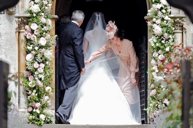 ENGLEFIELD GREEN, UNITED KINGDOM - MAY 20: (EMBARGOED FOR PUBLICATION IN UK NEWSPAPERS UNTIL 48 HOURS AFTER CREATE DATE AND TIME) Michael Middleton and Catherine, Duchess of Cambridge help Pippa Middleton with her wedding dress as she arrives for her wedding at St Mark's Church on May 20, 2017 in Englefield Green, England. (Photo by Max Mumby/Indigo/Getty Images)