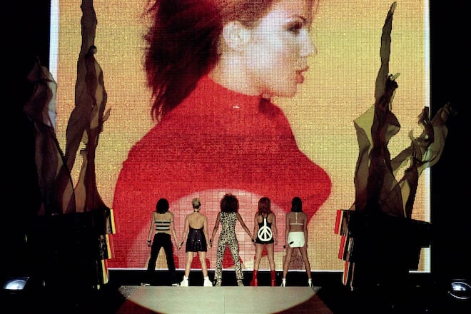 UNITED KINGDOM - FEBRUARY 24: BRIT AWARDS, EARLS COURT Photo of SPICE GIRLS, Group performing live on stage, giant screen L-R Melanie Chisholm (Mel C), Emma Bunton, Melanie Brown (Mel B), Geri Halliwell and Victoria Adams (Beckham) (Photo by JMEnternational/Redferns)