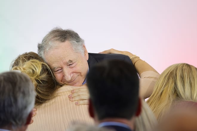 COLOGNE, GERMANY - JULY 20:  Jean Todt embraces Gina Schumacher, daughter of former Formula One champion Michael Schumacher at the awarding of the North Rhine-Westphalia State Prize to Michael Schumacher at Motorworld Köln on July 20, 2002 in Cologne, Germany.  (Photo by Andreas Rentz/Getty Images)