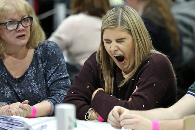 A member of the counting staff yawns during the count at the SEC Centre in Glasgow in the 2019 General Election. (Photo by Andrew Milligan/PA Images via Getty Images)