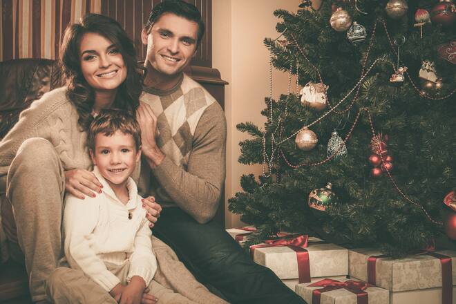 Happy family near Christmas tree in house interior