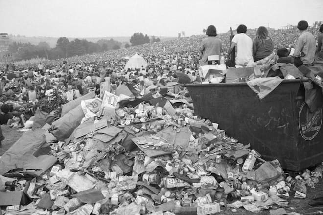 (Original Caption) WHITE LAKE, NEW YORK: Refuse overflows a trash bin as the Aquarian Rock Explosion ends early August 18. Estimates of up to half a million people have been made to describe the mobs who descended on a farm site here for three days of rock music, love, drugs, rain and mud.