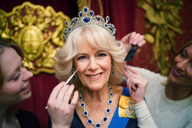 Studio artists Sophie Greenaway (left) and Claire Parkes add the finishing touches to a new Queen Consort wax figure at Madame Tussauds in London, ahead of the coronation of King Charles III on May 6. Picture date: Wednesday April 26, 2023. (Photo by Yui Mok/PA Images via Getty Images)
