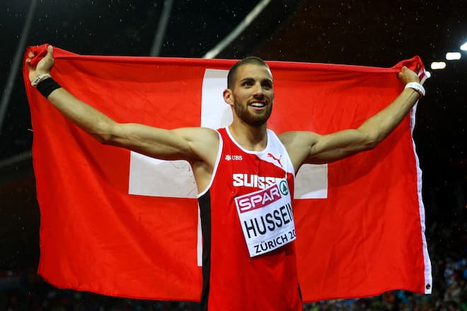 ZURICH, SWITZERLAND - AUGUST 15: Kariem Hussein of Switzerland celebrates with the national flag after winning gold in the Men's 400 metres hurdles final during day four of the 22nd European Athletics Championships at Stadium Letzigrund on August 15, 2014 in Zurich, Switzerland. (Photo by Michael Steele/Getty Images)