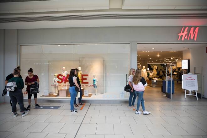 Shoppers queue to enter a Hennes & Mauritz AB (H&M) store at the Lakeside shopping centre, operated by Intu Properties Plc, in Thurrock, U.K., on Friday, June 19, 2020. U.K. retail sales started to recover last month from their precipitous drop during the coronavirus lockdown. Photographer: Chris Ratcliffe/Bloomberg via Getty Images