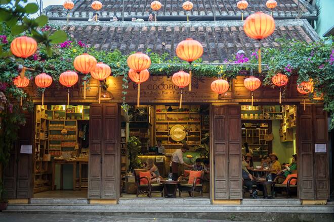 Customers sit at Cocobox cafe and juice bar in the old town of Hoi An, Qung Nam Province, Vietnam, on Sunday, April 22, 2018. With a fast-growing economy and a young population, Vietnam offers an attractive market for retailers. Its economy expanded 7.4 percent in the first quarter from the same period a year earlier, and a third of its population is aged 15 to 34. Photographer: James MacDonald/Bloomberg via Getty Images