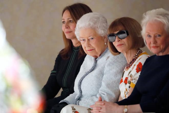 LONDON, ENGLAND - FEBRUARY 20: (L-R) Chief Executive of the British Fashion Council Caroline Rush, Queen Elizabeth II and Anna Wintour attend the Richard Quinn show during London Fashion Week February 2018 on February 20, 2018 in London, England. (Photo by Tristan Fewings/BFC/Getty Images)