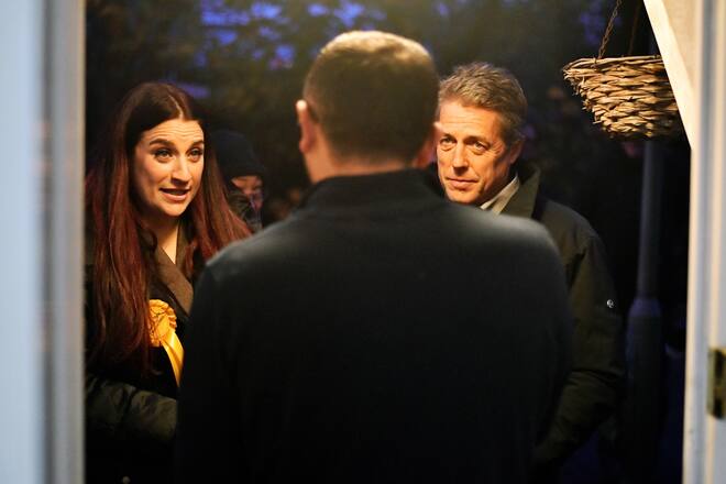 LONDON, ENGLAND - DECEMBER 01: Actor Hugh Grant and Liberal Democrat Luciana Berger (L) speak to a local resident during a campaign event in Finchley on December 1, 2019 in London, England. UK voters are set to go to the polls on December 12 in the country's third general election in less than five years. (Photo by Leon Neal/Getty Images)