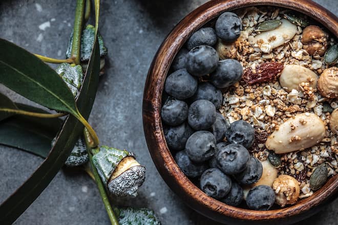 A healthy gluten free breakfast cereal, made fresh and served with blueberries, and a budding switch of blue gum.