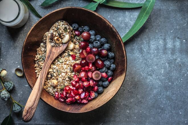A healthy gluten free breakfast cereal, made fresh and served with blueberries, red grapes and pomegranate seeds.
