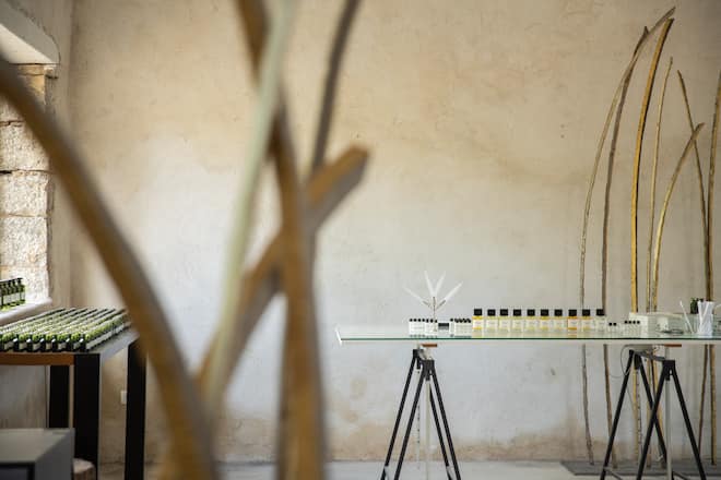a perfume atelier with many bottles on two tables
