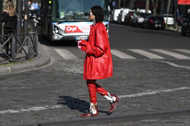 PARIS, FRANCE - MARCH 08: A guest is seen wearing a red coat, red pants and cowboy boots with white sunglasses and diamond earrings outside the Chanel show during Paris Fashion Week A/W 2022 on March 08, 2022 in Paris, France. (Photo by Daniel Zuchnik/Getty Images)