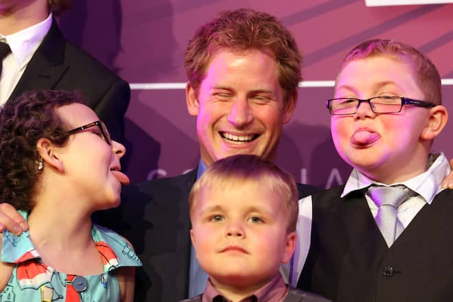 LONDON, UNITED KINGDOM - SEPTEMBER 03: Prince Harry poses with (L-R) Rose Whittle, 9, Alex Logan, 6, and Matthew Merritt, 9, at the WellChild Awards at the Intercontinental Hotel on September 3, 2012 in London, England. (Photo by Lewis Whyld - WPA Pool/Getty Images)