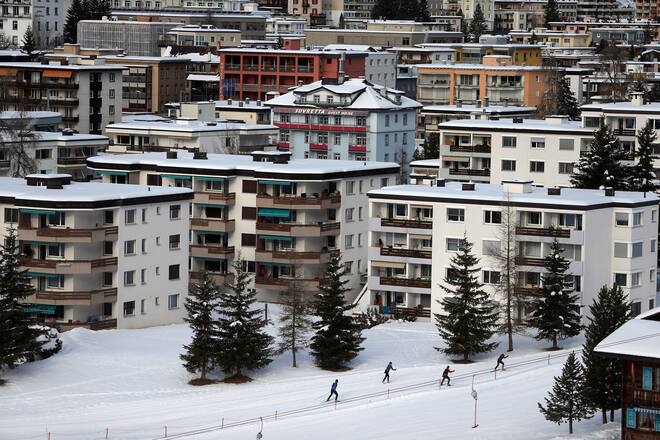 Cross country skiers make they way past snow covered buildings in Davos, Switzerland, on Saturday, Jan. 18, 2014. Next week the business elite will gather in the Swiss Alps for the 44th annual meeting of the World Economic Forum (WEF) in Davos for the five day event which runs from Jan. 22-25. Photographer: Simon Dawson/Bloomberg via Getty Images