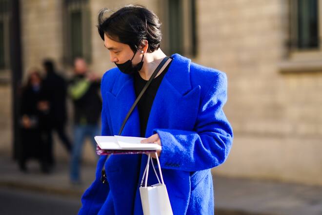 PARIS, FRANCE - JANUARY 20: A guest wears a blue oversized jacket with shoulder pads, a black top, earrings, a face mask, outside Dior, during Paris Fashion Week - Haute Couture Spring/Summer 2020, on January 20, 2020 in Paris, France. (Photo by Edward Berthelot/Getty Images )