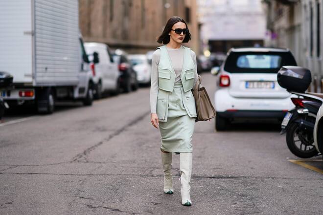 MILAN, ITALY - FEBRUARY 20: Mary Leest wears sunglasses, a pale green jacket, a gray top, a skirt, gray thigh high pointy boots, a brown leather bag, outside Max Mara, during Milan Fashion Week Fall/Winter 2020-2021 on February 20, 2020 in Milan, Italy. (Photo by Edward Berthelot/Getty Images)