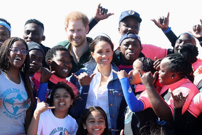 CAPE TOWN, SOUTH AFRICA - SEPTEMBER 24: Prince Harry, Duke of Sussex and Meghan, Duchess of Sussex poses with surf mentors as they visit Waves for Change, an NGO, at Monwabisi Beach on September 24, 2019 in Cape Town, South Africa. Waves for Change supports local surf mentors to provide mental health services to vulnerable young people living in under resourced communities. (Photo by Chris Jackson - Pool/Getty Images)