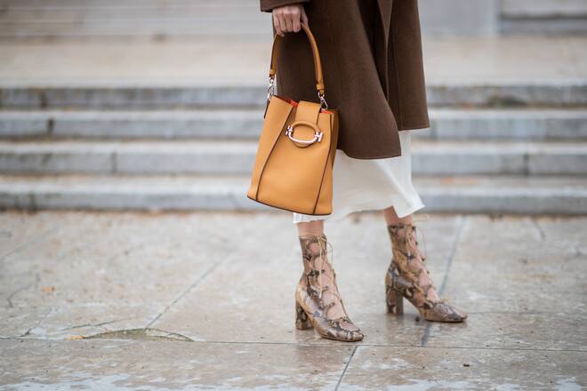 PARIS, FRANCE - MARCH 05: Leonie Hanne is seen wearing laced boots with snake print, brown coat, orange bag, dress outside Tods lunch during Paris Fashion Week Womenswear Fall/Winter 2019/2020 on March 05, 2019 in Paris, France. (Photo by Christian Vierig/Getty Images)
