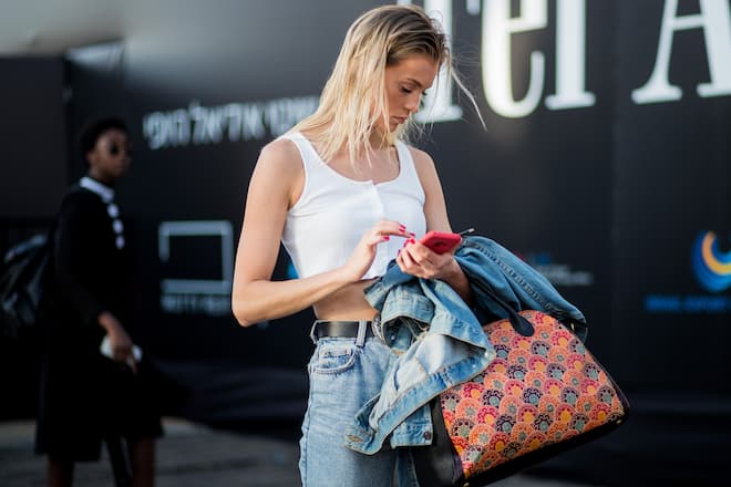 TEL AVIV, ISRAEL - MARCH 13: A model with wet hair wearing white cropped top, denim jeans is seen during Tel Aviv Fashion Week on March 13, 2018 in Tel Aviv, Israel. (Photo by Christian Vierig/Getty Images)