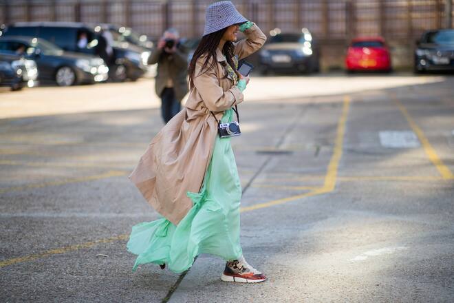 PARIS, FRANCE - FEBRUARY 27: Erika Boldrin (R) wears a turtleneck, a grey jacket with apparent white seams, a purple puff bag ; Blanca Miro (L) wears a black hat, a grey sleeveless vest, grey pants, a red puff bag, outside Maison Margiela, during Paris Fashion Week Womenswear Fall/Winter 2019/2020, on February 27, 2019 in Paris, France. (Photo by Edward Berthelot/Getty Images)