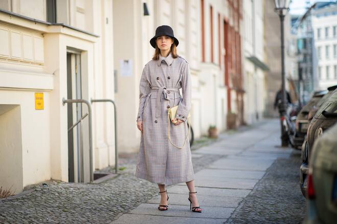 PARIS, FRANCE - FEBRUARY 27: Erika Boldrin (R) wears a turtleneck, a grey jacket with apparent white seams, a purple puff bag ; Blanca Miro (L) wears a black hat, a grey sleeveless vest, grey pants, a red puff bag, outside Maison Margiela, during Paris Fashion Week Womenswear Fall/Winter 2019/2020, on February 27, 2019 in Paris, France. (Photo by Edward Berthelot/Getty Images)