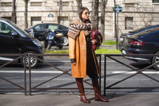 PARIS, FRANCE - MARCH 03: Julia Haghjoo wears sunglasses, a brown leather coat, a purple leather bag, a wool pullover with printed patterns, black pants, leather boots, outside Miu Miu, during Paris Fashion Week - Womenswear Fall/Winter 2020/2021 on March 03, 2020 in Paris, France. (Photo by Edward Berthelot/Getty Images)