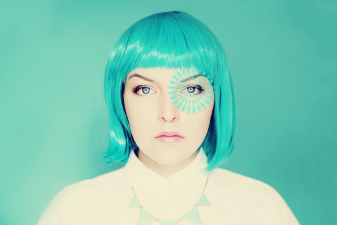 Young woman with blue hair and blue pulse light from her left eye