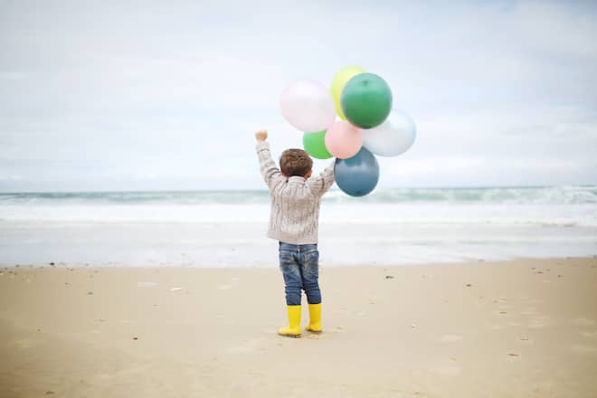 A 3 years old boy playing on the beach