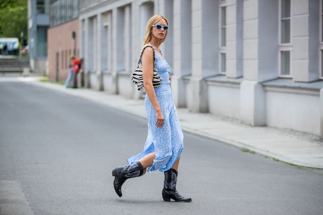 BERLIN, GERMANY - SEPTEMBER 07: Cheyenne Tulsa is seen wearing blue dress, cowboy boots, bag with zebra print, blue sunglasses during Fashion Week Berlin on September 07, 2021 in Berlin, Germany. (Photo by Christian Vierig/Getty Images)