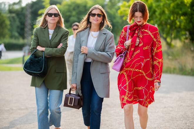 COPENHAGEN, DENMARK - AUGUST 07: Tine Andrea wearing green blazer, denim jeans, Darja Barannik wearing navy blue denim jeans, grey blazer and Marianne Theodorsen wearing red dress with print seen outside Samsøe & Samsøe during Copenhagen Fashion Week Spring/Summer 2020 on August 07, 2019 in Copenhagen, Denmark. (Photo by Christian Vierig/Getty Images)