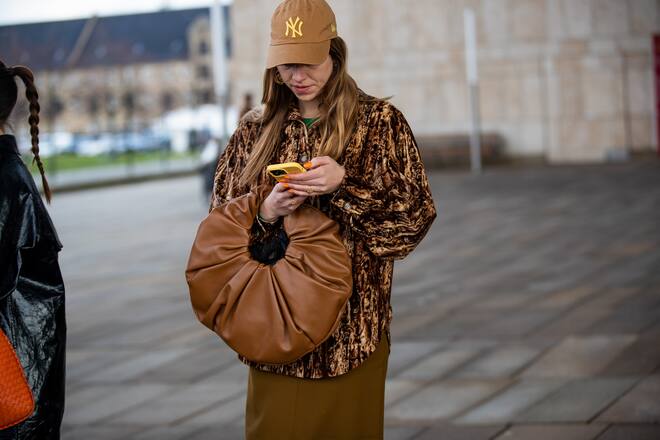 COPENHAGEN, DENMARK - FEBRUARY 02: Trine Kjaer wearing brown bag, cap outside Saks Potts during Copenhagen Fashion Week Autumn/Winter 2022 on February 02, 2022 in Copenhagen, Denmark. (Photo by Christian Vierig/Getty Images)