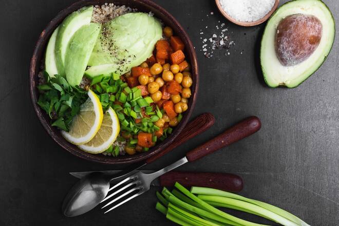 Healthy chickpea avocado quinoa bowl on gray background viewed from above, favorite vegan meal