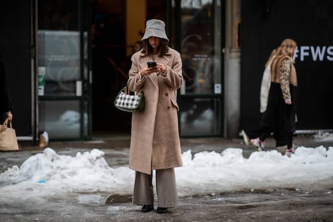 STOCKHOLM, SWEDEN - FEBRUARY 05: Felicia Akerstrom Ma wearing bucket hat, beige wool coat and Mulberry bag is seen during Stockholm Runway February Autumn Winter 2019 on February 05, 2019 in Stockholm, Sweden. (Photo by Christian Vierig/Getty Images)