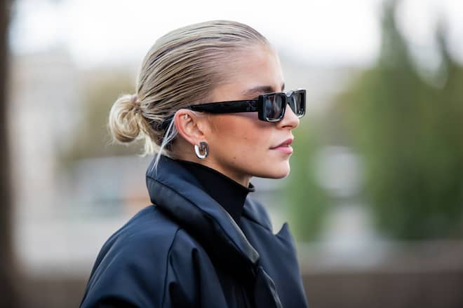 PARIS, FRANCE - OCTOBER 04: Caroline Daur seen wearing black shorts, turtleneck, down feather jacket, Prada bag, sunglasses outside Giambattista Valli during Paris Fashion Week - Womenswear Spring Summer 2022 on October 04, 2021 in Paris, France. (Photo by Christian Vierig/Getty Images)