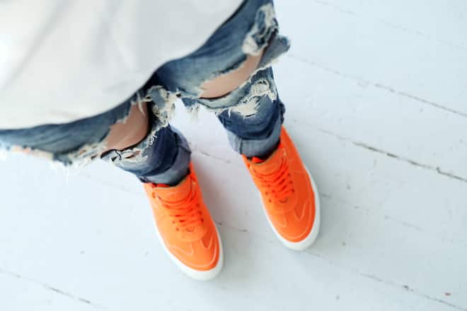 Girl in torn jeans Woman wearing torn jeans and orange boots PUBLICATIONxINxGERxSUIxAUTxONLY Copyright: xyekostockx 13703250