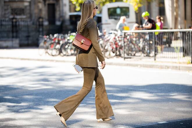 LONDON, ENGLAND - SEPTEMBER 12: A guest is seen wearing brown corduroy flared pants and blazer, brown bag outside Roberta Einer during London Fashion Week September 2019 on September 12, 2019 in London, England. (Photo by Christian Vierig/Getty Images)