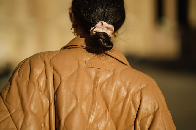 PARIS, FRANCE - OCTOBER 19: Gabriella Berdugo wears an oversized beige shiny leather quilted zipper bomber coat from Miu Miu, on October 19, 2021 in Paris, France. (Photo by Edward Berthelot/Getty Images)