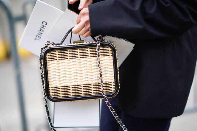 PARIS, FRANCE - MAY 03: A guest wears a rattan Chanel bag, outside the Chanel Cruise Collection 2020 At Grand Palais on May 03, 2019 in Paris, France. (Photo by Edward Berthelot/Getty Images )