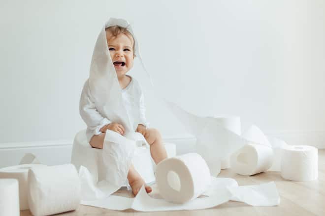 Cute hild sitting on white potty and crying. A little girl does not want to write to the chamberpot. Sick baby constipation colic, bloating, indigestion heartburn, digestion, pain, diarrhea.