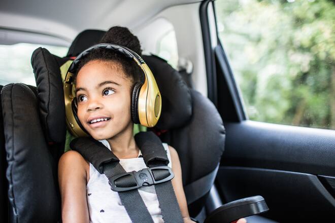 Girl (6yrs) wearing headphones in car
