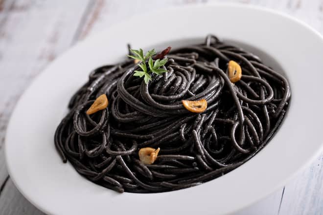 Close up of spaghetti al nero di sepia, with garlic, chili and squid ink