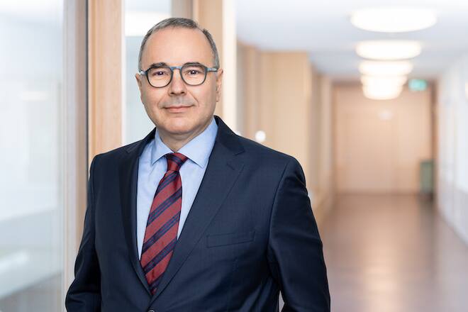 a portrait of a man in a suit and with glasses