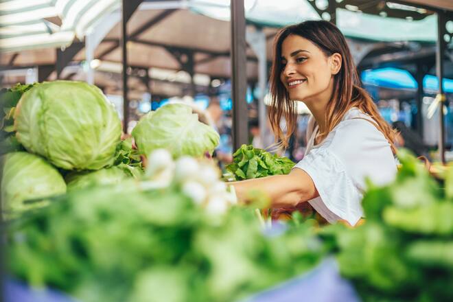 Young cheerful woman at the market