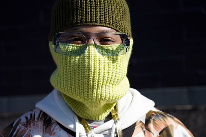 NEW YORK, NEW YORK - FEBRUARY 16: A guest wears Burberry glasses and a green knit cap with a face covering during New York Fashion Week: The Shows at Spring Studios on February 16, 2021 in New York City. (Photo by Cindy Ord/Getty Images)
