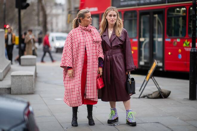 LONDON, ENGLAND - FEBRUARY 18: Janka Polliani wearing red plaid coat and Annabel Rosendahl wearing bordeaux leather coat, bag with tiger print, hiking boots is seen outside Erdem during London Fashion Week February 2019 on February 18, 2019 in London, England. (Photo by Christian Vierig/Getty Images)