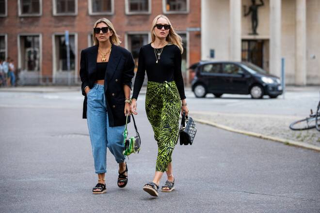 COPENHAGEN, DENMARK - AUGUST 08: Aylin König is seen wearing denim jeans, cropped top, blazer, Prada bag, sandals and Juliane Diesner wearing skirt with jungle print outside Saks Potts during Copenhagen Fashion Week Spring/Summer 2020 on August 08, 2019 in Copenhagen, Denmark. (Photo by Christian Vierig/Getty Images)