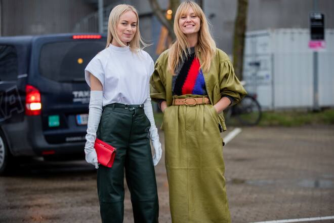COPENHAGEN, DENMARK - JANUARY 29: Thora Valdimars wearing green pants, gloves, white shirt, red bag and Jeanette Friis Madsen wearing green shirt and jacket, striped knit seen outside Holzweiler during Copenhagen Fashion Week Autumn/Winter 2020 Day 2 on January 29, 2020 in Copenhagen, Denmark. (Photo by Christian Vierig/Getty Images)