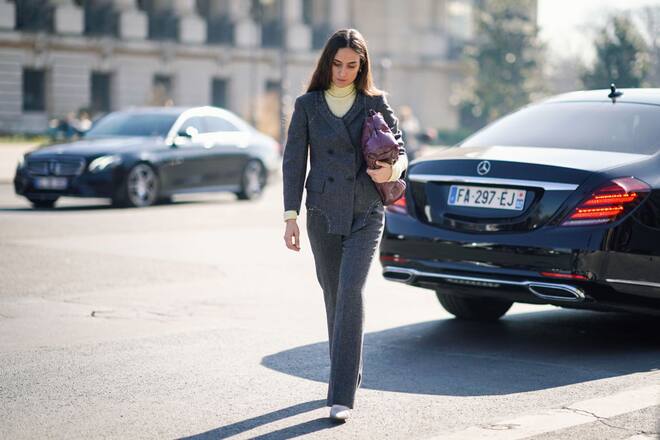 PARIS, FRANCE - FEBRUARY 27: Erika Boldrin wears a turtleneck, a grey jacket with apparent white seams, grey flare pants, white pointy shoes, a purple puff bag, outside Maison Margiela, during Paris Fashion Week Womenswear Fall/Winter 2019/2020, on February 27, 2019 in Paris, France. (Photo by Edward Berthelot/Getty Images)